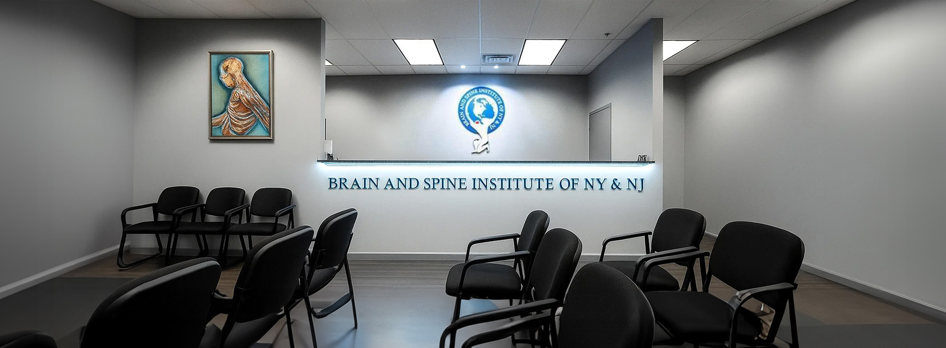 The image shows a room with chairs arranged facing a wall where a sign reads  Brain and Spine Institute of N Y.  A religious icon is displayed on the wall above the sign, and there s a person in the background seated at a desk.