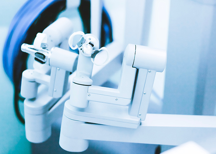 An industrial robotic arm with two end effectors, ready for operation in a clean room environment.